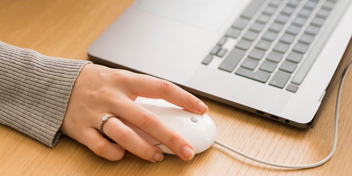 side-close-up-woman-hand-over-mouse-laptop